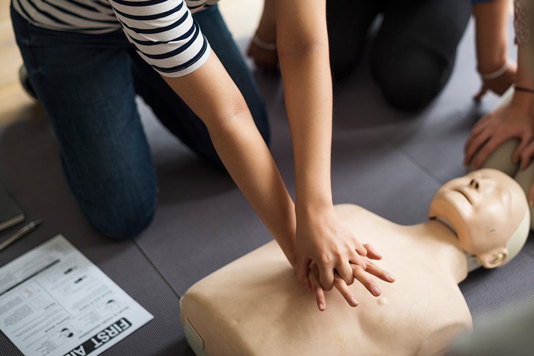 Close up of woman giving CPR on a manikin