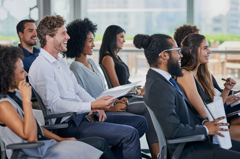 Professionals attending a leadership and management training session for business development and coaching in the workplace.